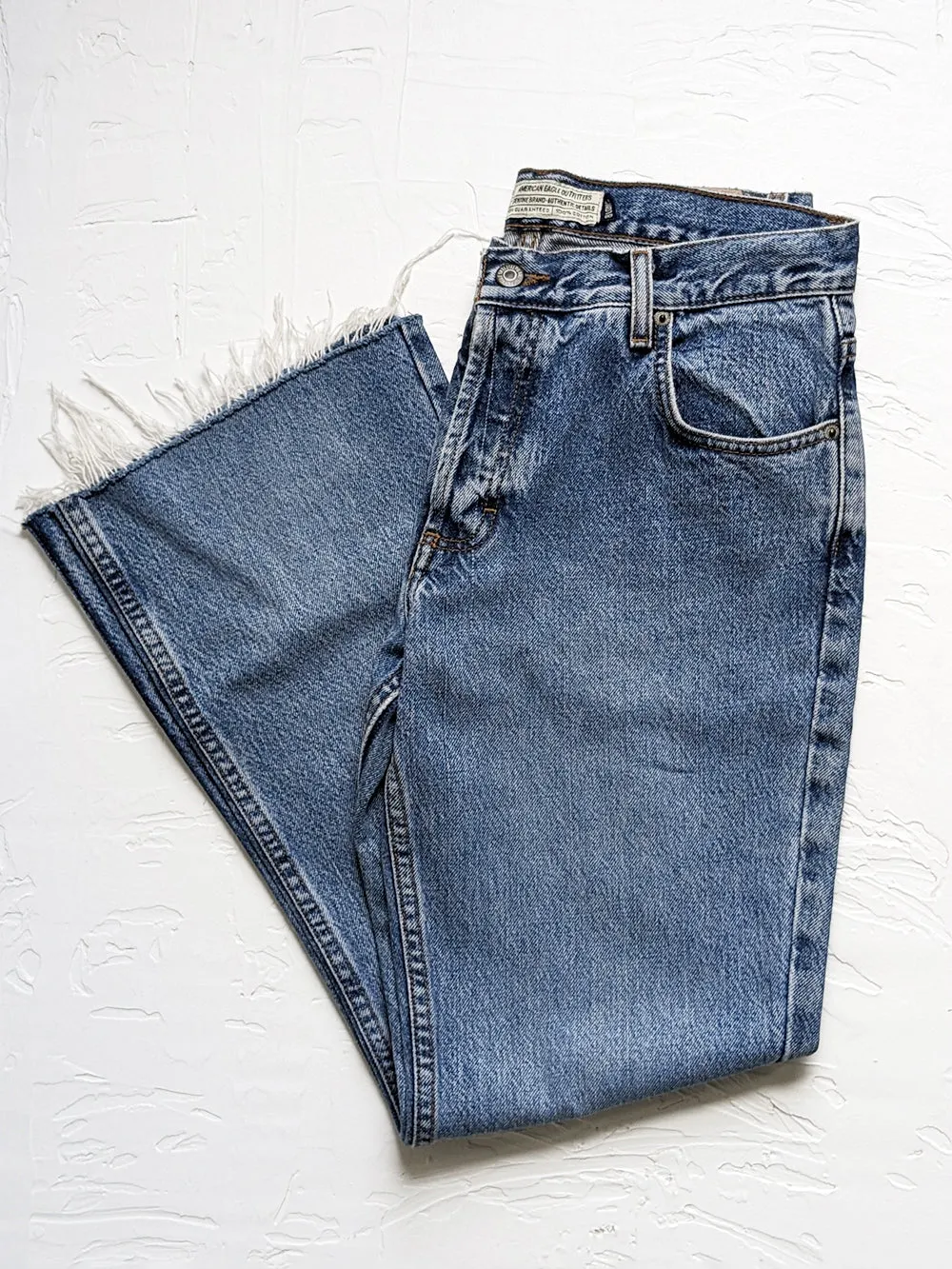 AE Medium Wash Raw Edge Kick Flare Jeans