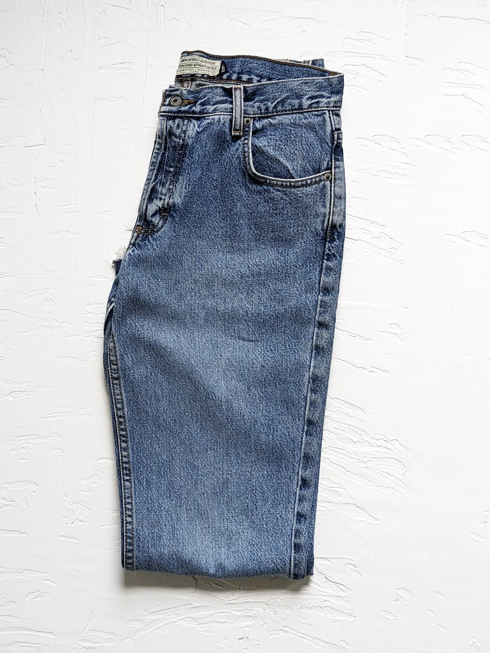 AE Medium Wash Raw Edge Kick Flare Jeans